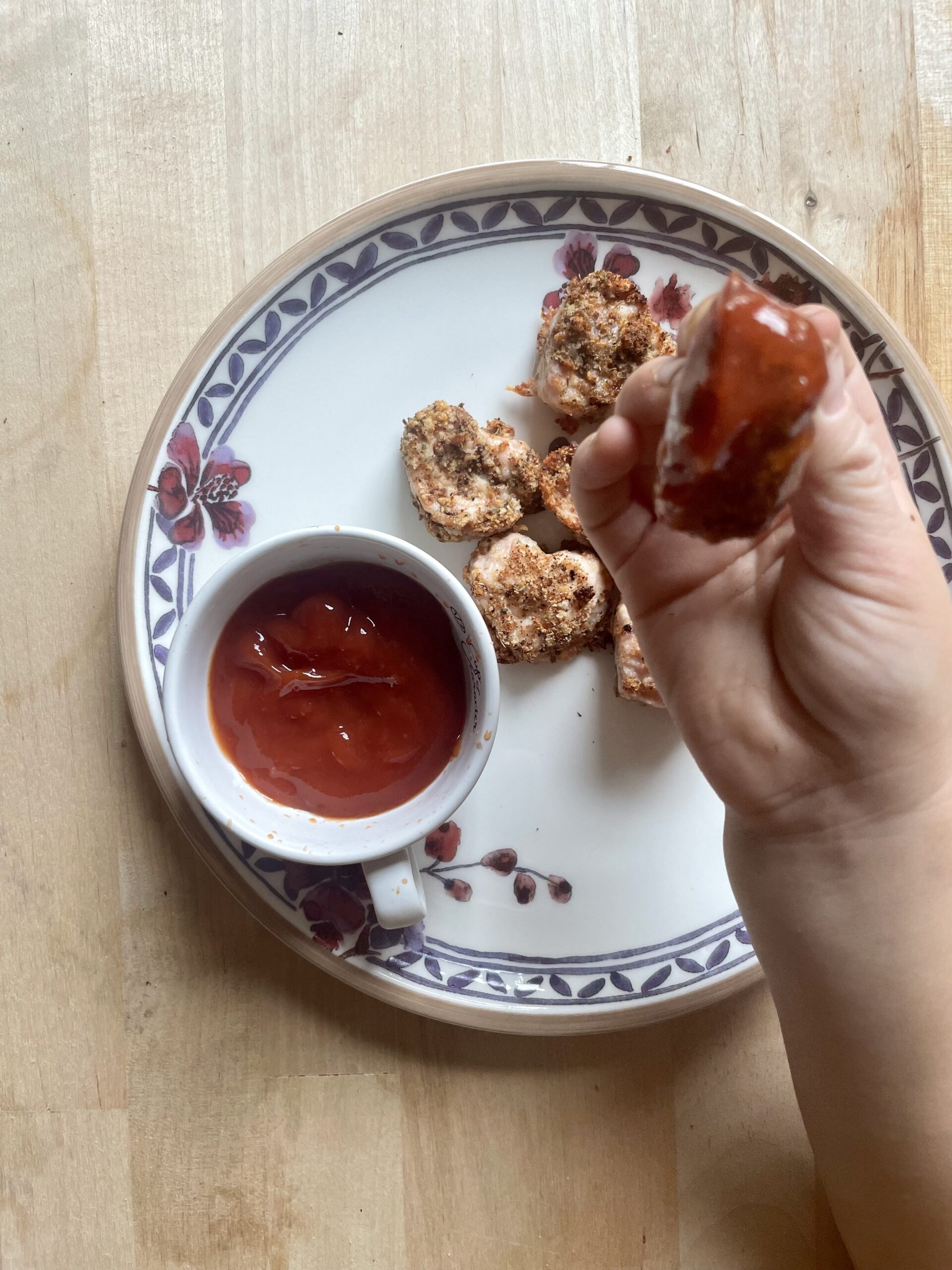 image of child's hand holding chicken nugget