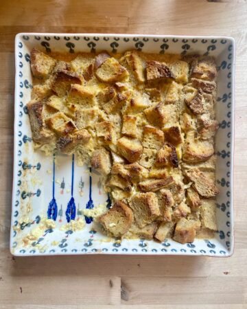 image of sourdough bread pudding in baking dish being eaten