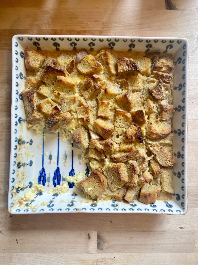 image of sourdough bread pudding in baking dish being eaten