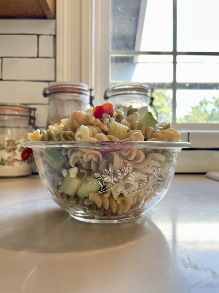 bowl of summer pasta salad with vegetables, salami and cheese