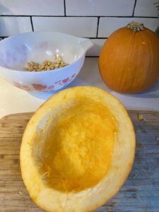 homemade pumpkin puree prep pumpkin cut in half with seeds & pulp removed