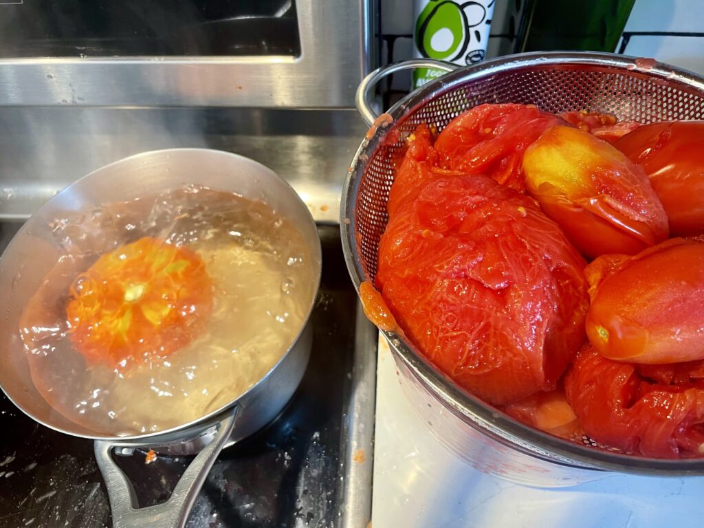 tomatoes peeled in a colander to use tomatoes as juice