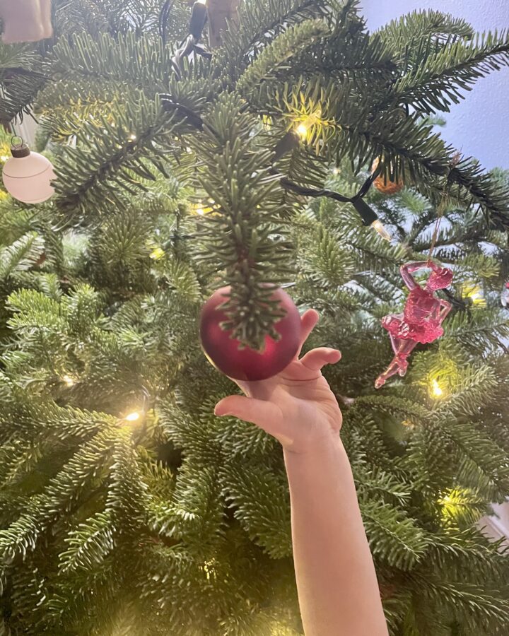 image of child holding a Christmas Ornament