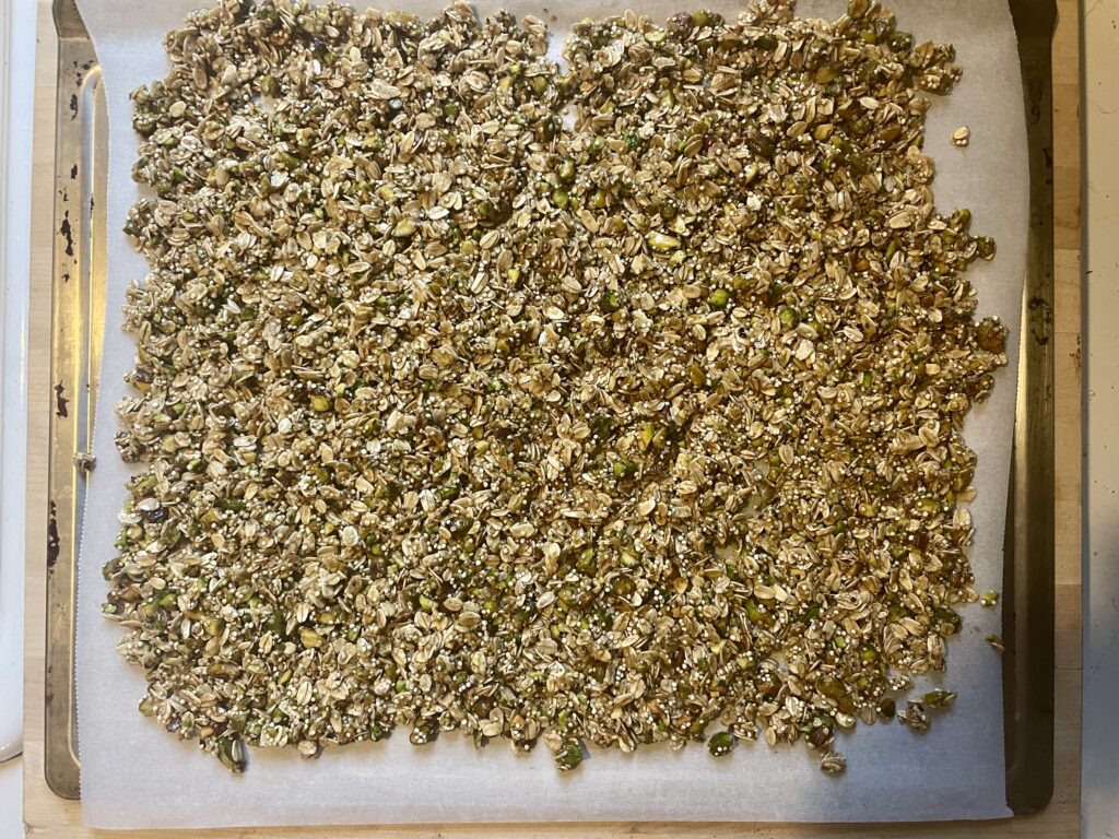 Homemade Granola spread out on a baking sheet