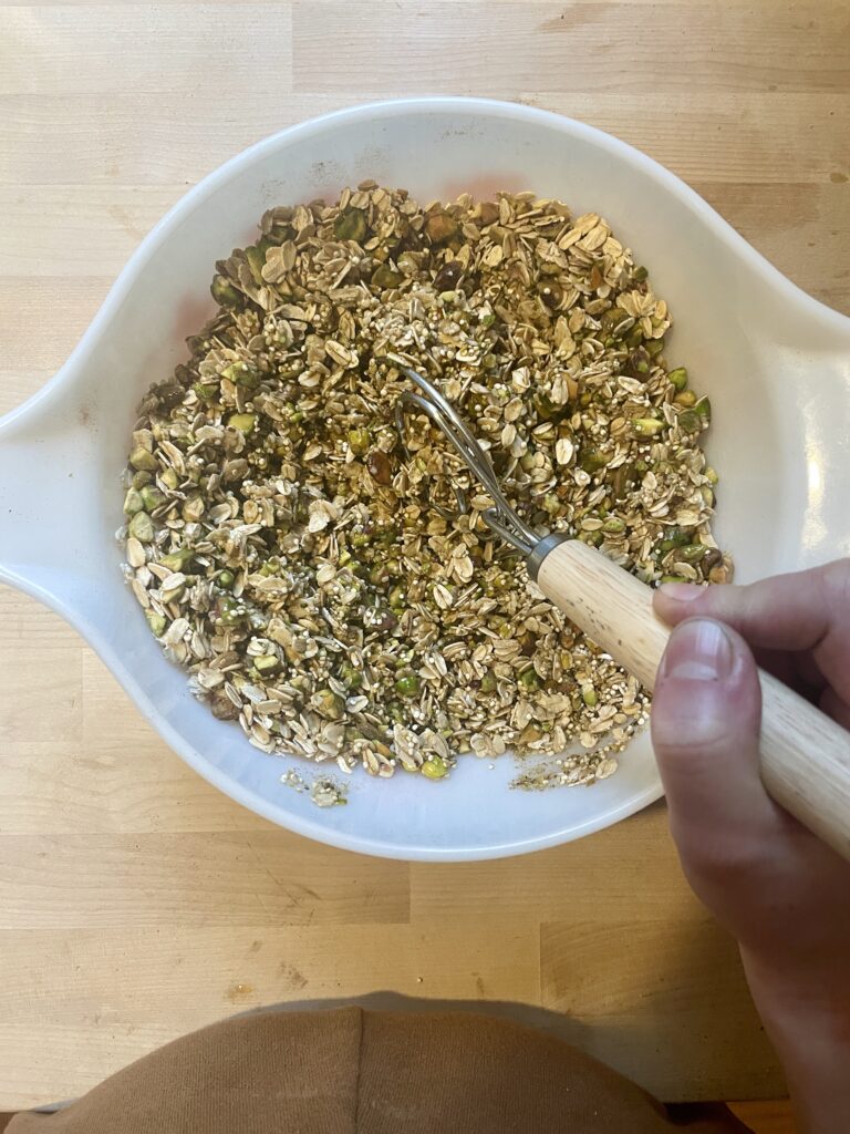 Mixing together wet and dry ingredients for Homemade Granola